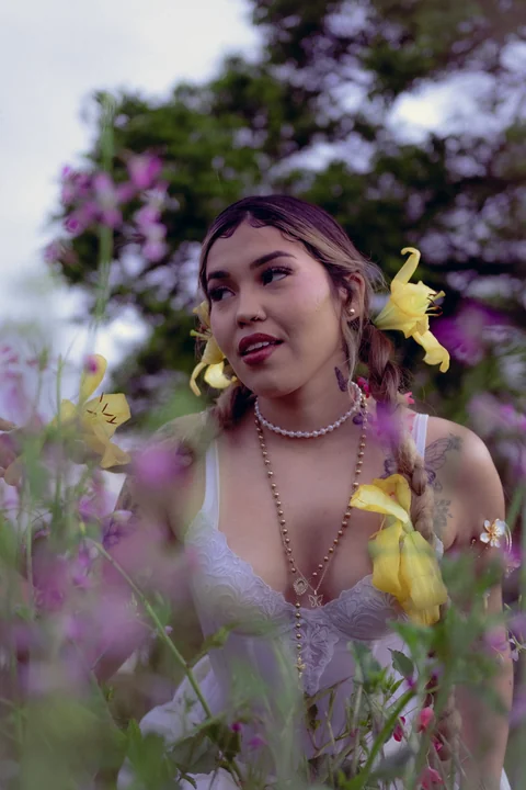 Portrait with violet flowers in the foreground.
