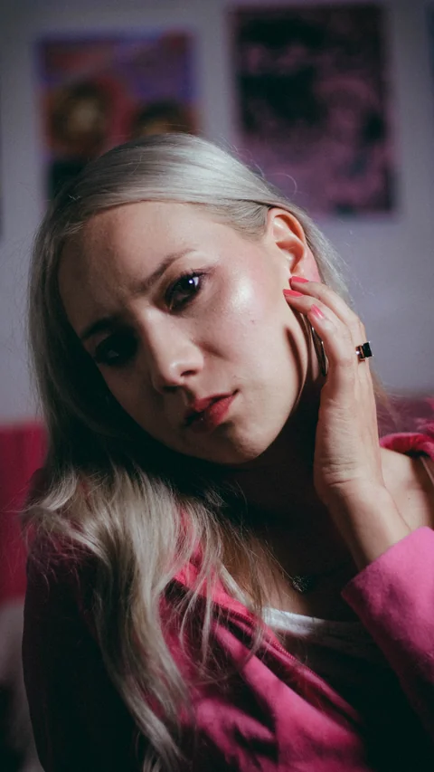 Portrait in a pink jacket with side lighting.