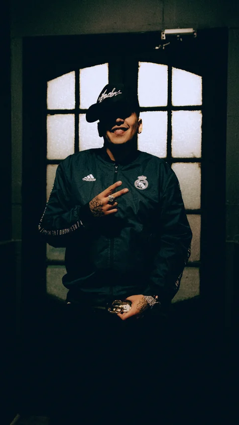 Portrait in a dark jacket in front of a window.